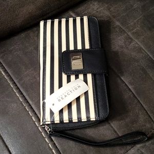 Kenneth Cole Reaction wallet. Fits a phone several pockets for credit cards/pics